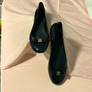 Tory Burch jelly slip on shoes.  Black with gold trim.  Gentle used.  Enjoy!
